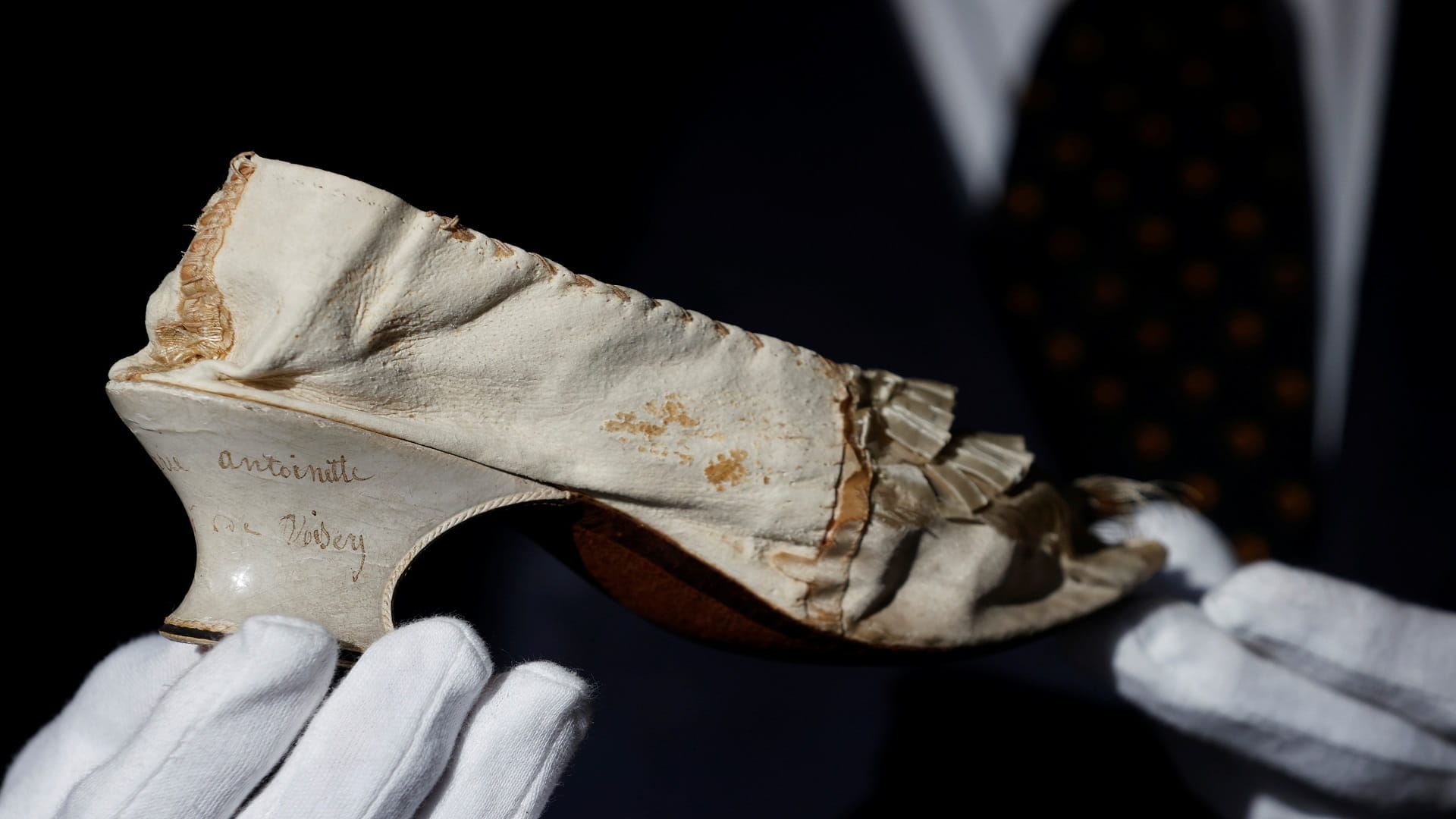 Image for the title: Marie Antoinette's silk shoe goes up for sale in Versailles 