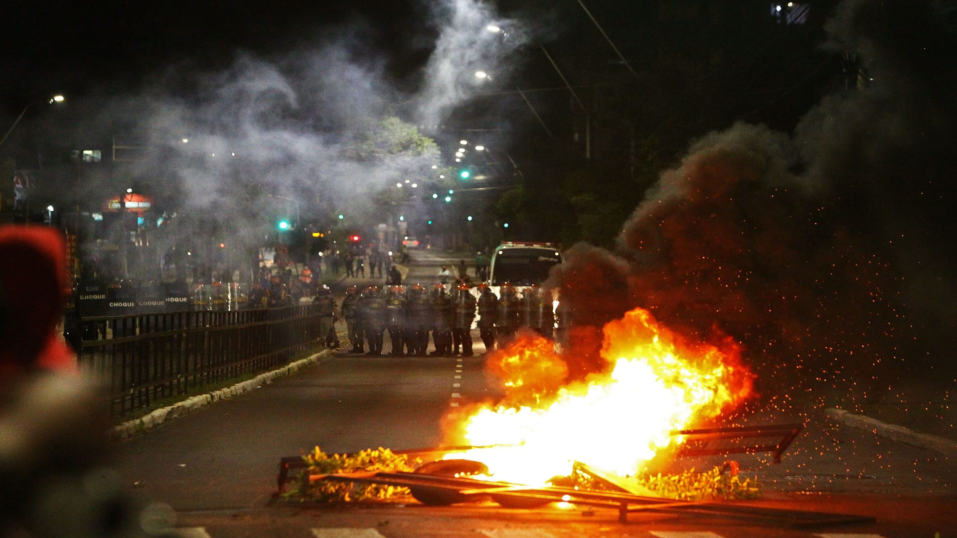 Image for the title: Brazil police fire tear gas at protests over Black man's killing 