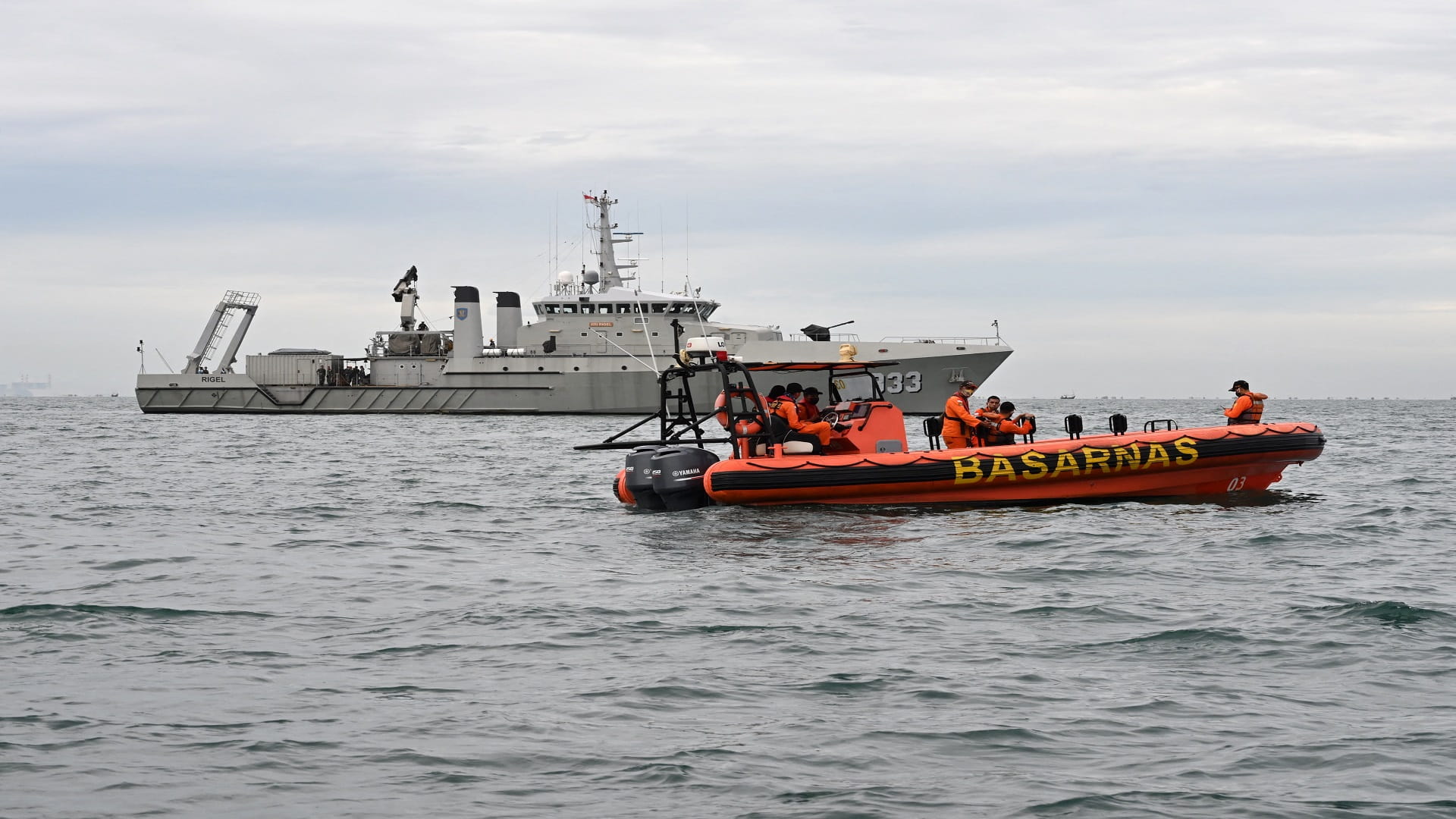 Image for the title: Indonesian divers hunt 17 missing after fishing boat 