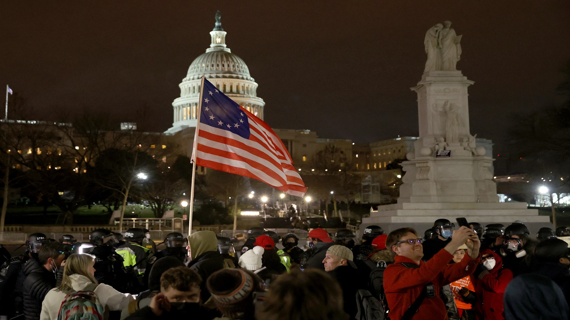 Image for the title: Guns out: Trump crowd turns Congress into battlefield 