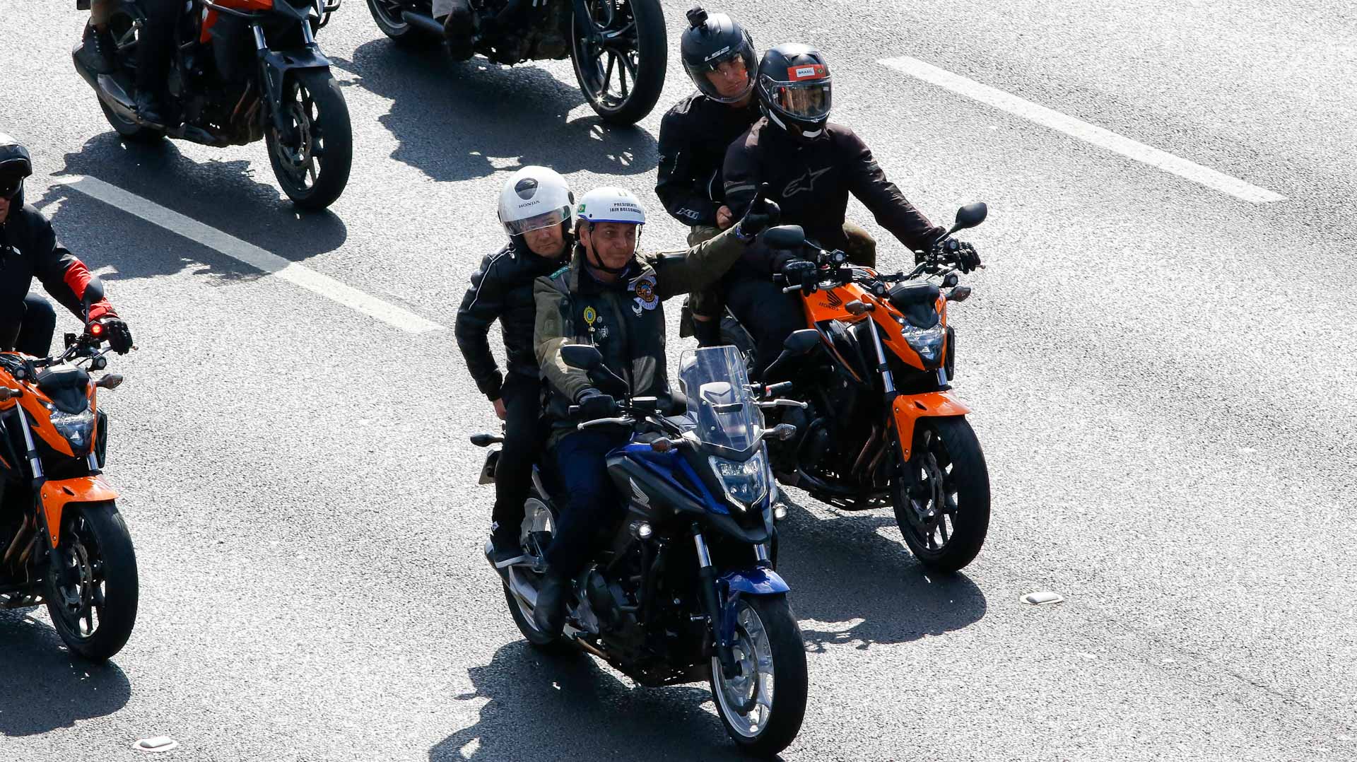 Image for the title: Brazil's Bolsonaro fined for maskless motorcyle rally 