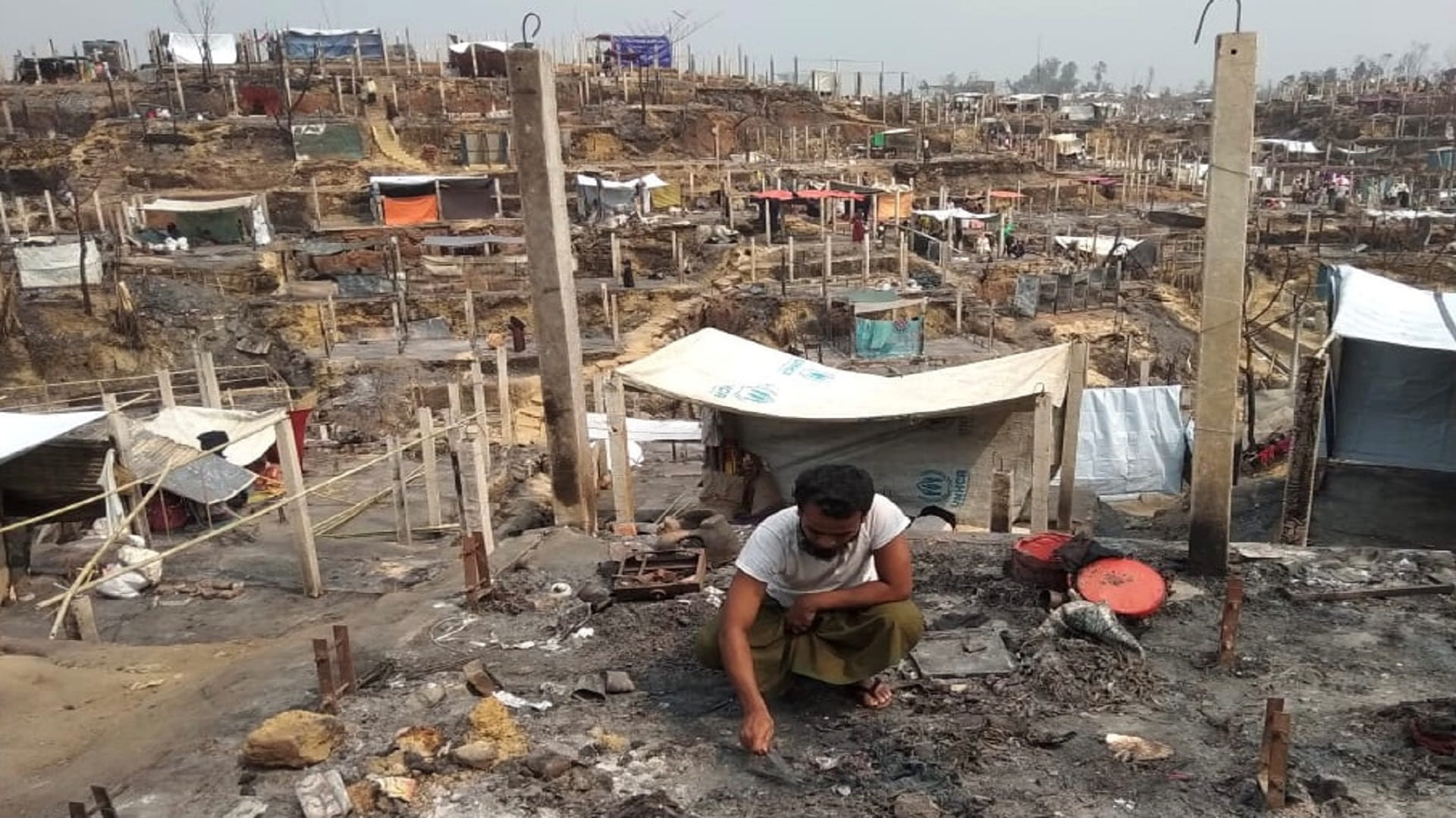 Image for the title: Rohingya refugees in Bangladesh rebuild huts after deadly fire 