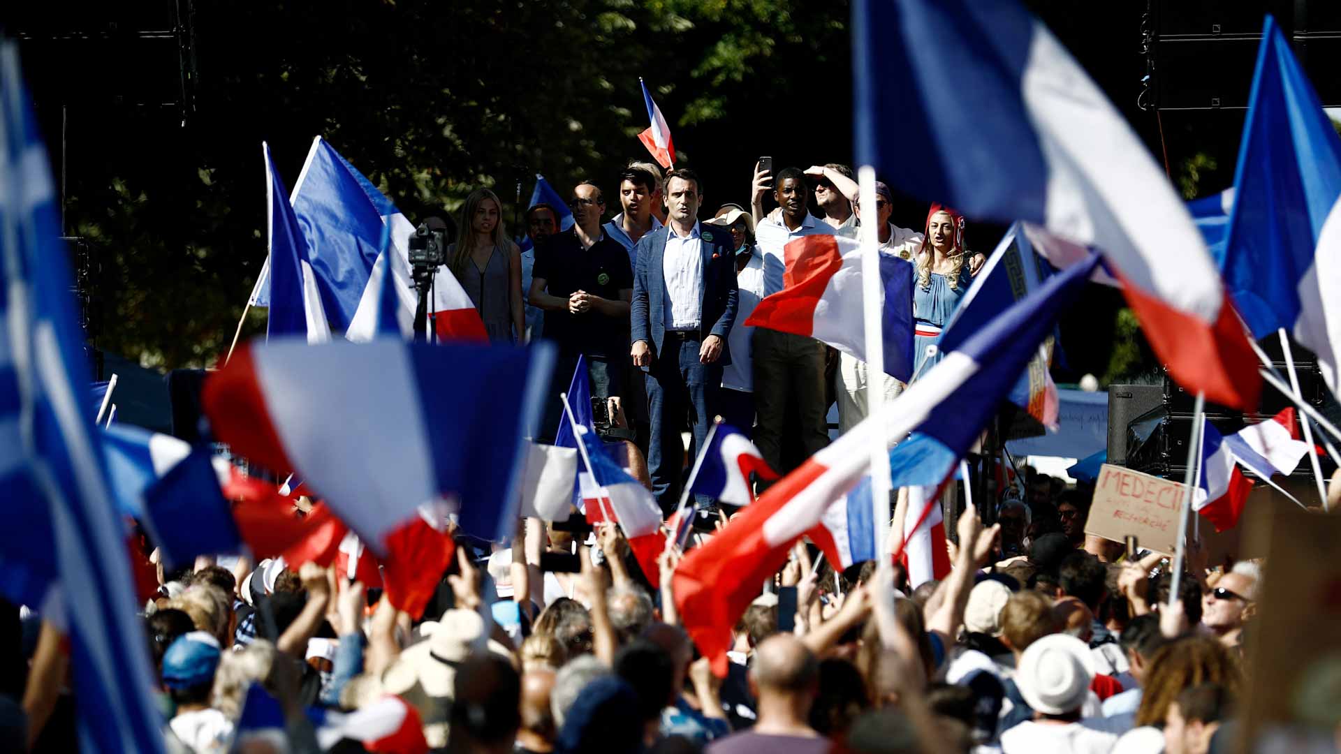 Image for the title: France sees fifth weekend of protests against Macron Covid pass 