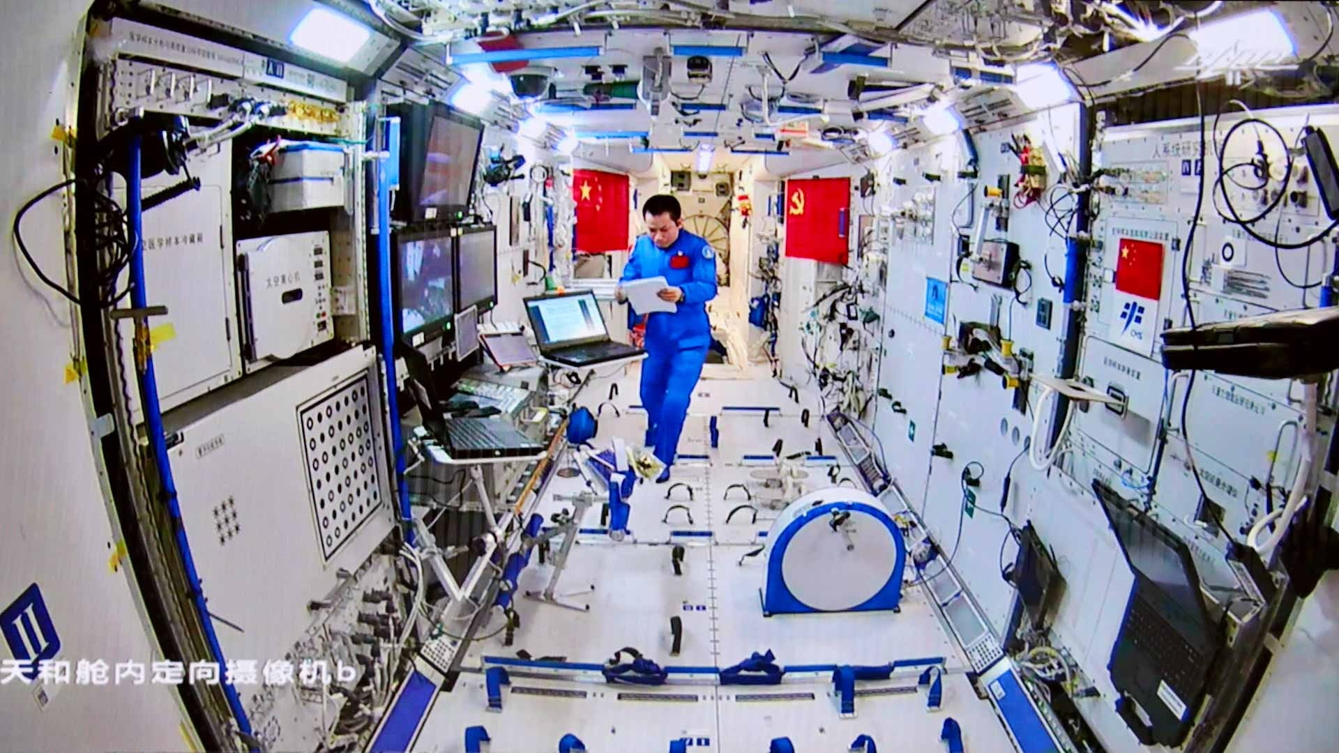 Image for the title: China's astronauts make spacewalk to upgrade robotic arm 