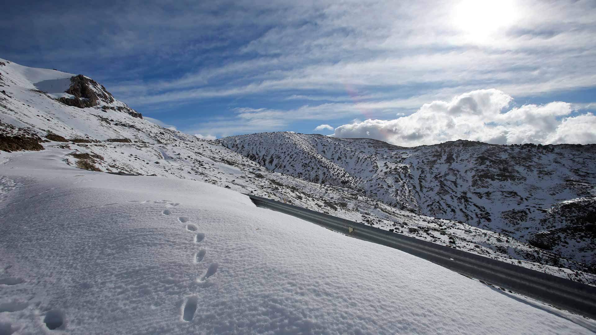 Image for the title: As snow blankets Algerian mountains,snowboarding enthusiasts trek 