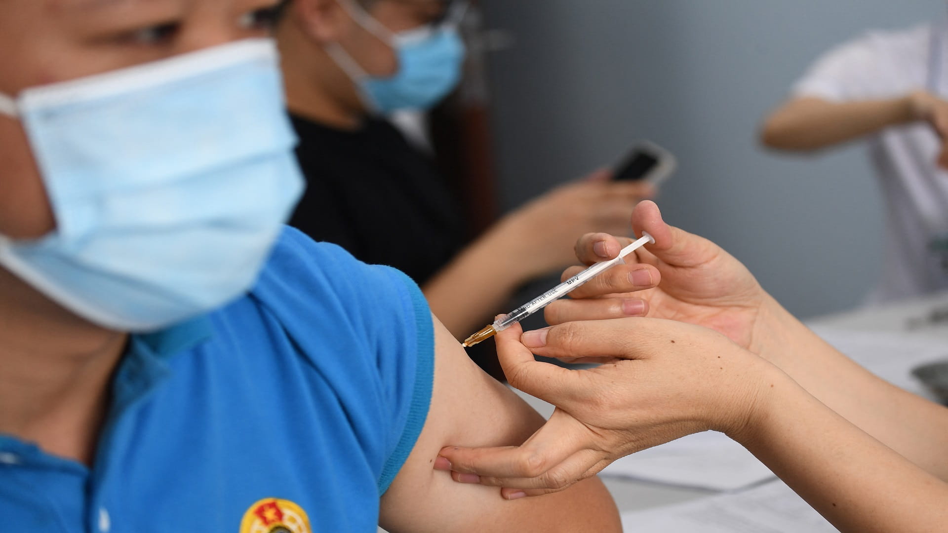 Image for the title: Vietnam sets COVID-19 vaccination targets as new curbs unrolled 