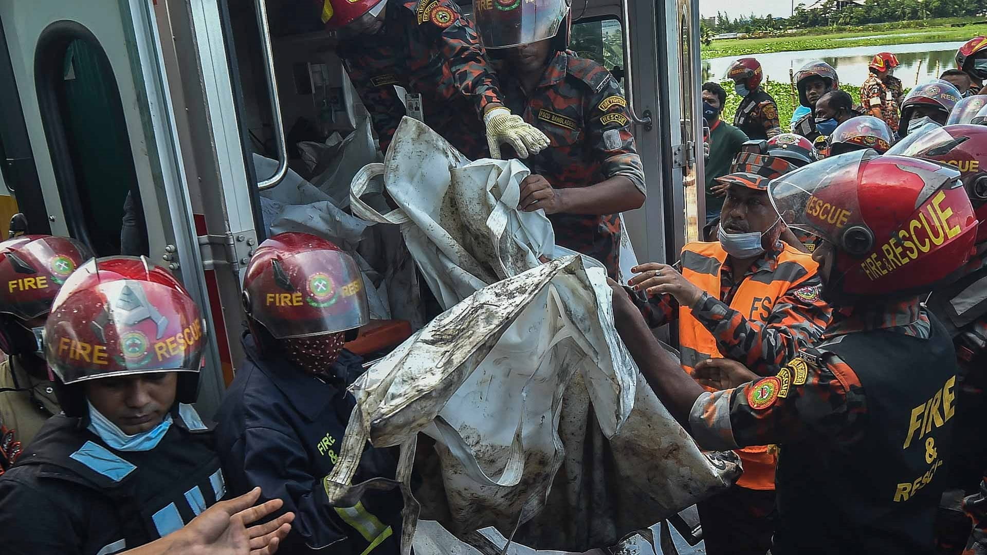 Image for the title: Bangladesh factory fire toll at 52 as workers locked inside 