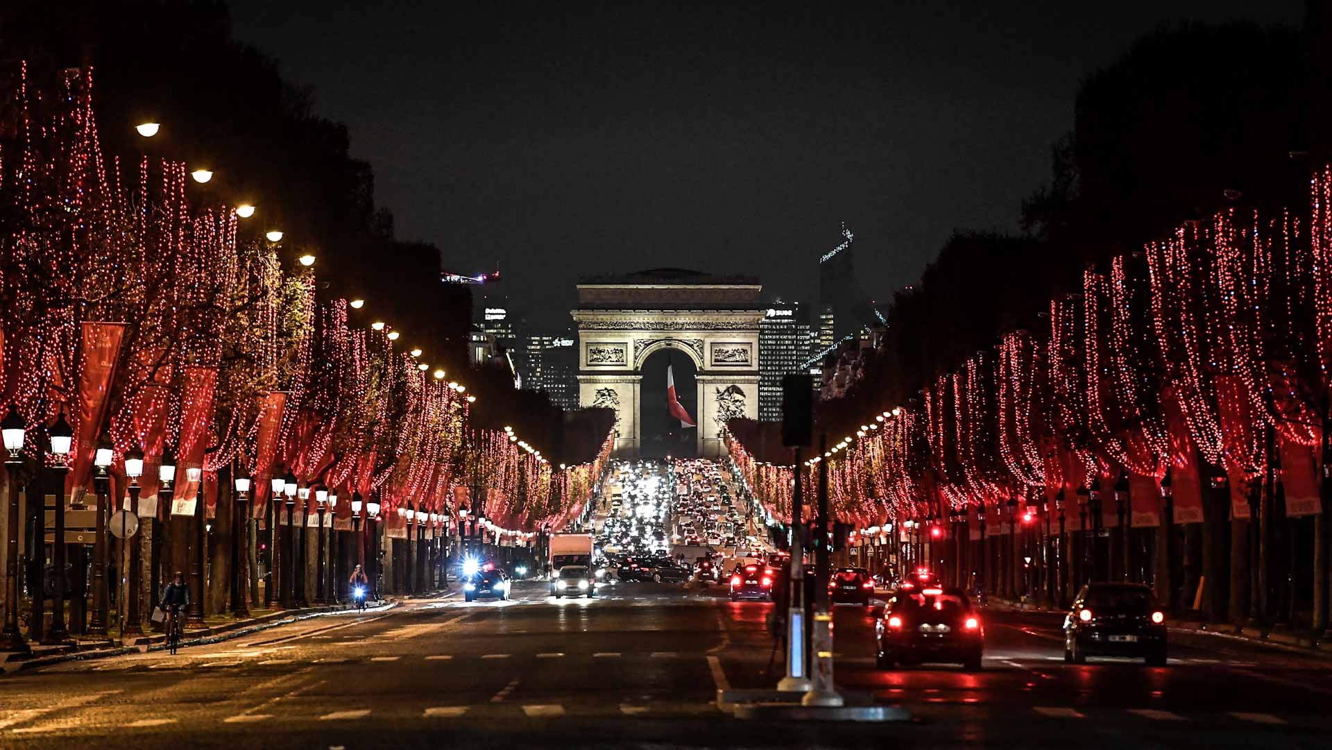 Image for the title: Champs Elysees avenue in Paris lights up in red for end of year 