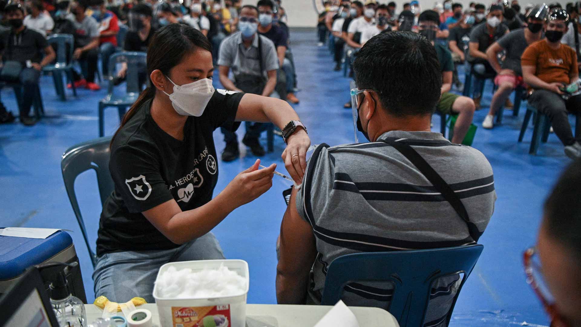 Image for the title: Philippines lifts lockdown in capital as virus surges 