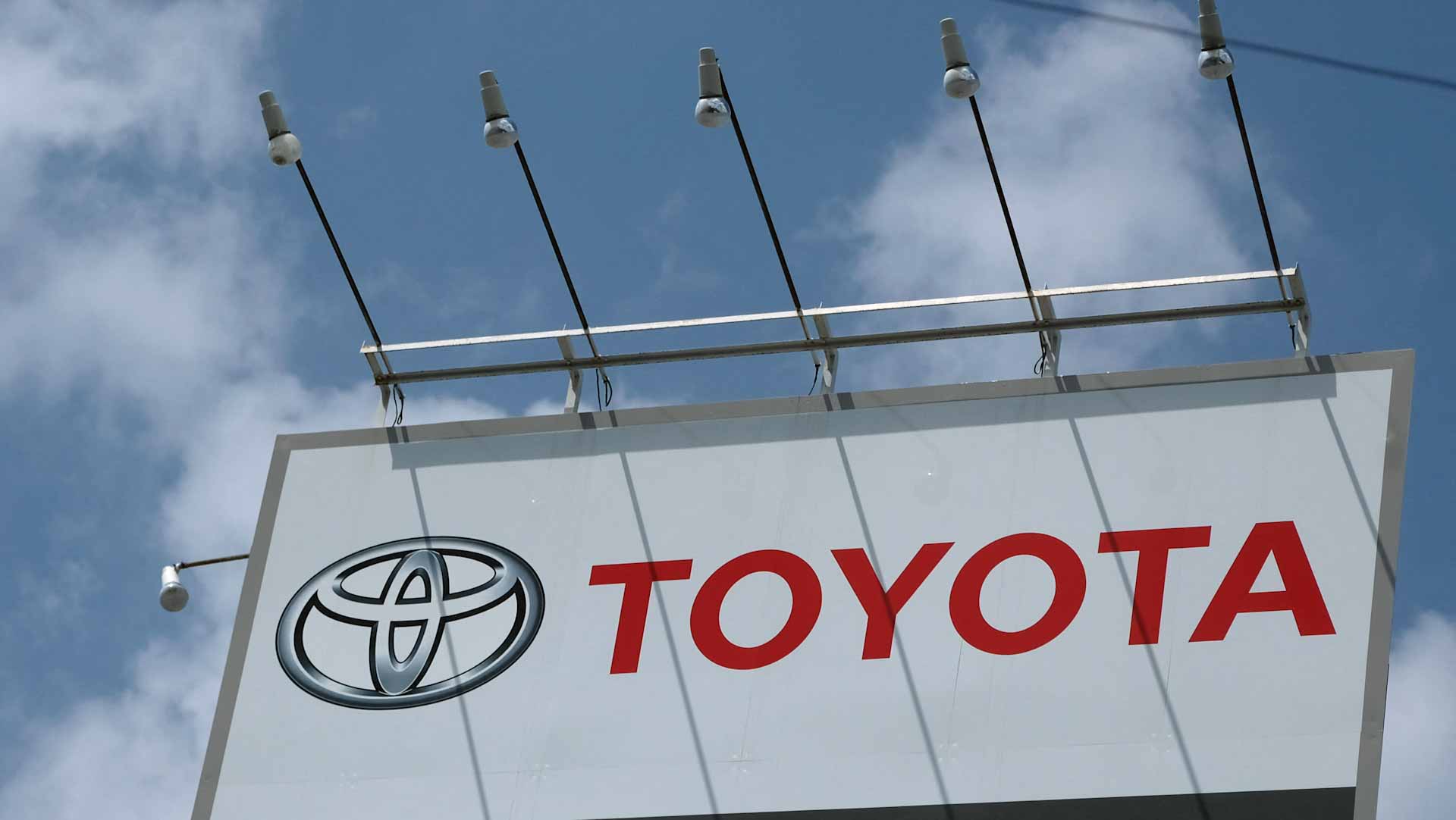 Image for the title: Toyota cuts production further on virus issues, chip woes 