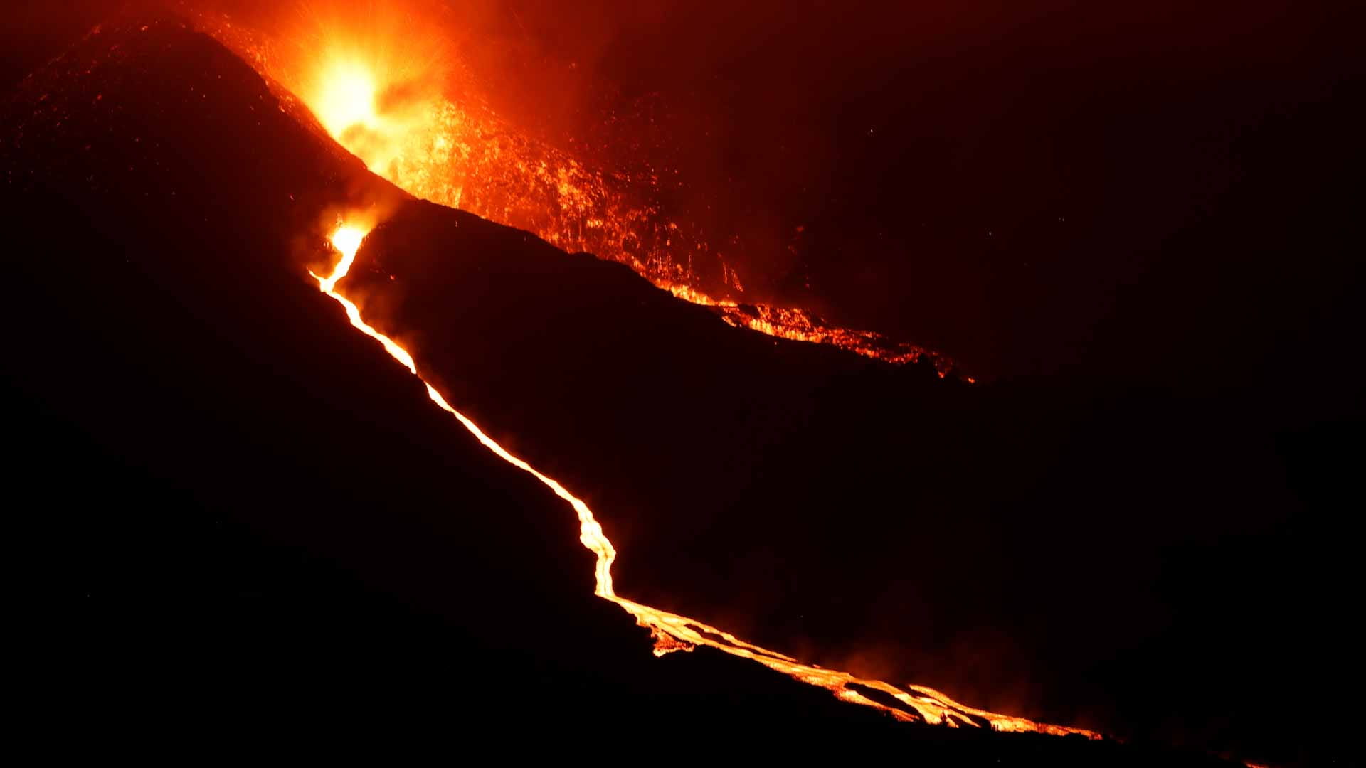 Image for the title: Red hot lava spews from La Palma volcano as eruption intensifies 