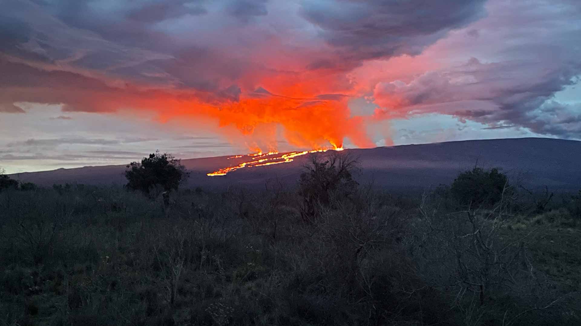 Image for the title: Visitors flock to Hawaiian volcano to see glowing lava flows 