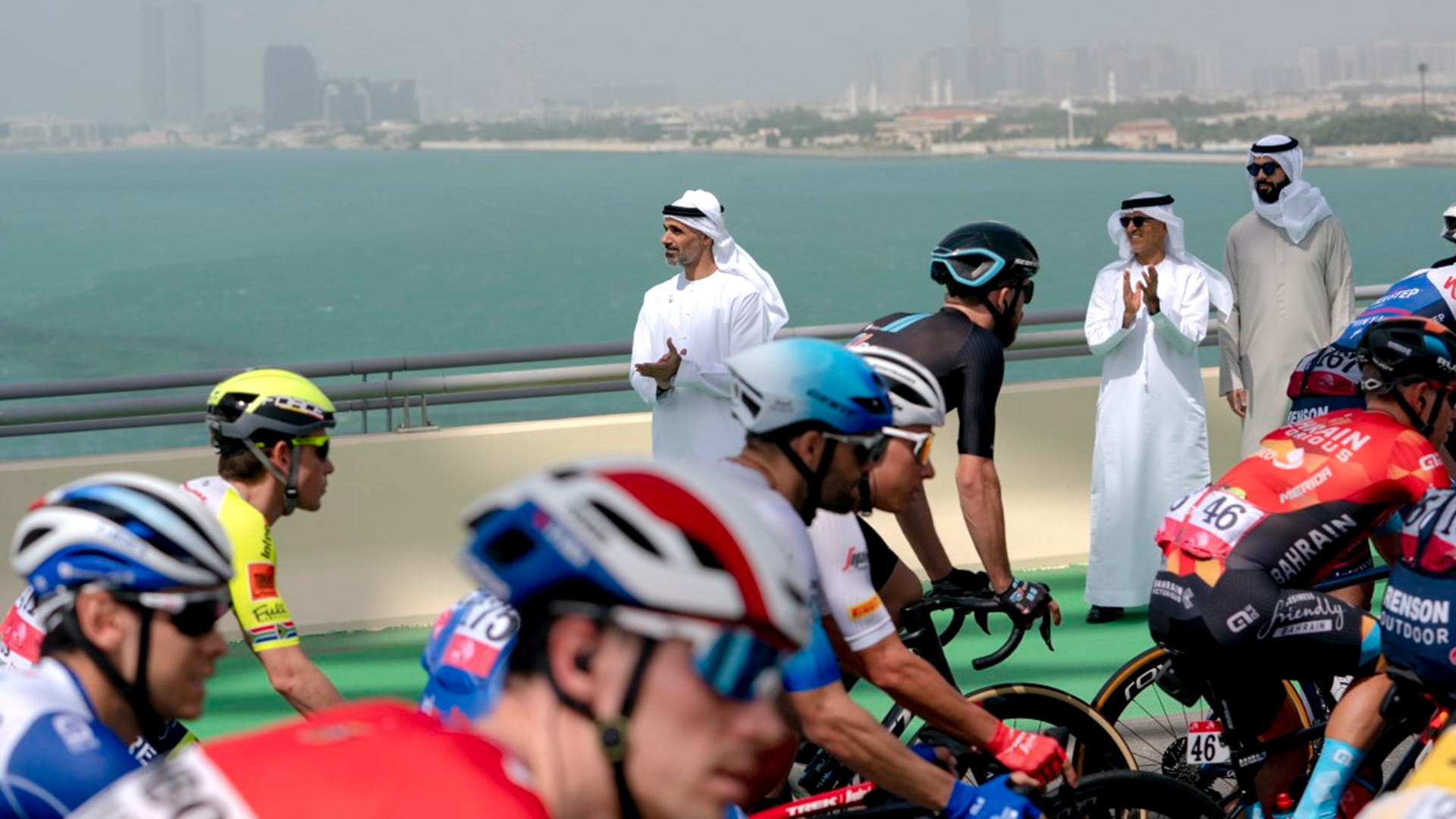 Image for the title: Khaled bin Mohamed greets cyclists starting stage two of UAE Tour 