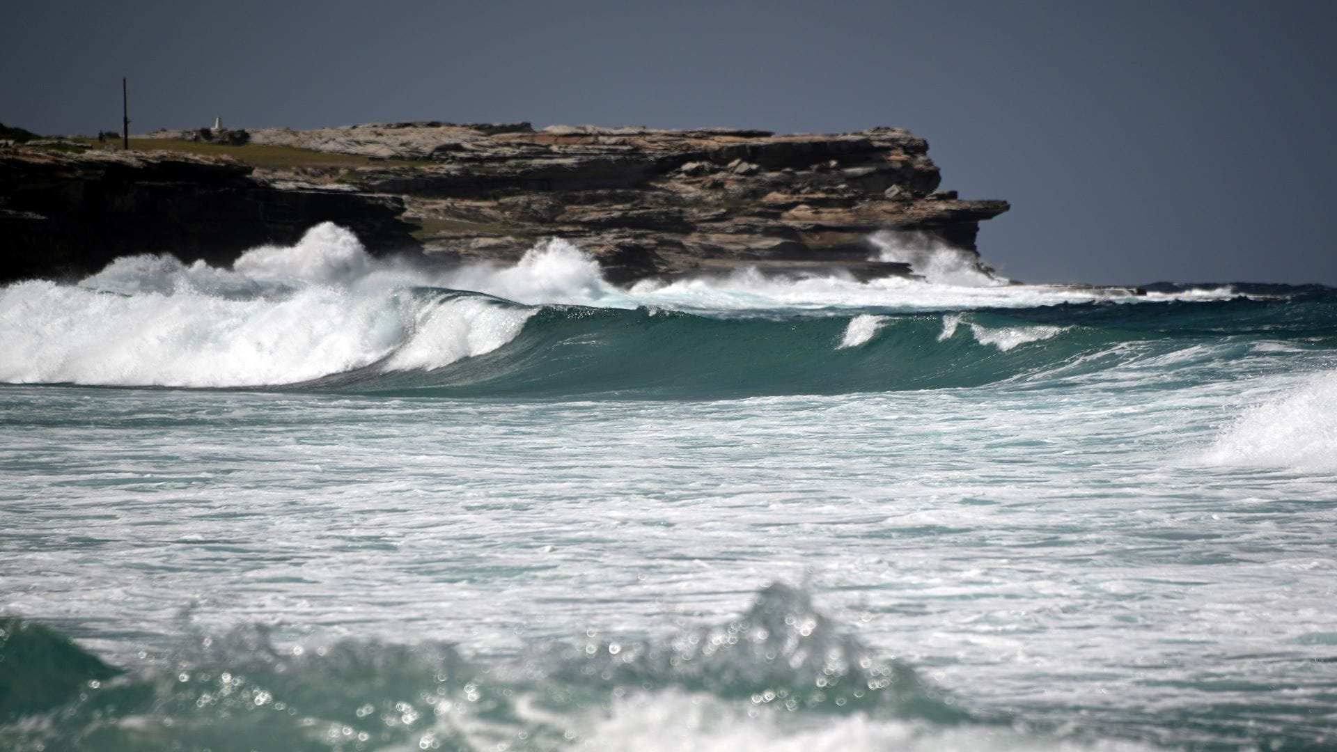 Image for the title: Tsunami waves crash ashore in Tonga after powerful eruption 