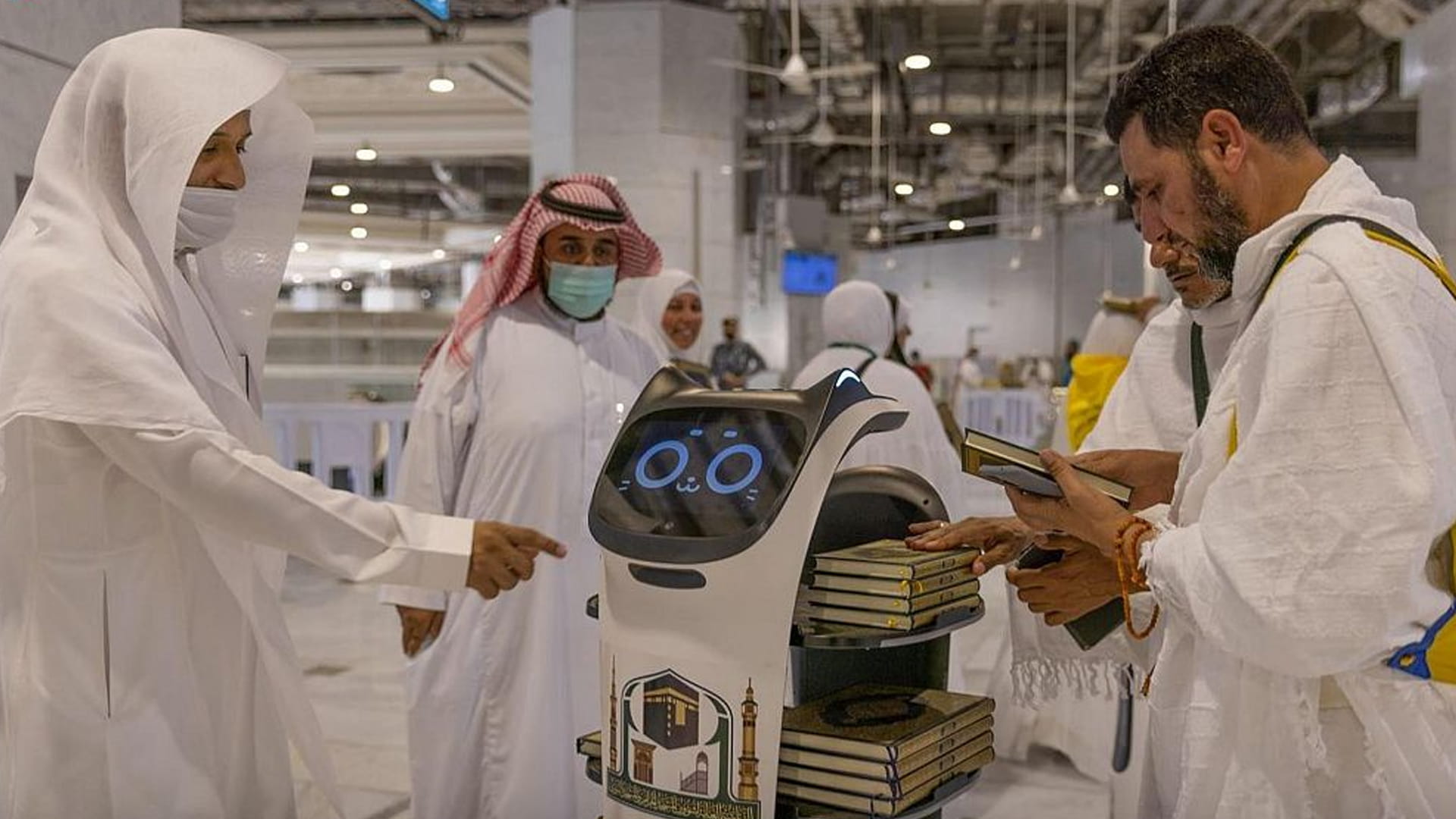 Image for the title: S. Arabia uses robots to distribute holy Quran among pilgrims 