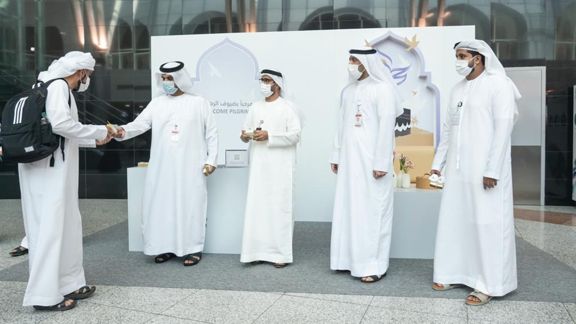 Image for the title: Sharjah Airport receives pilgrims with flowers 