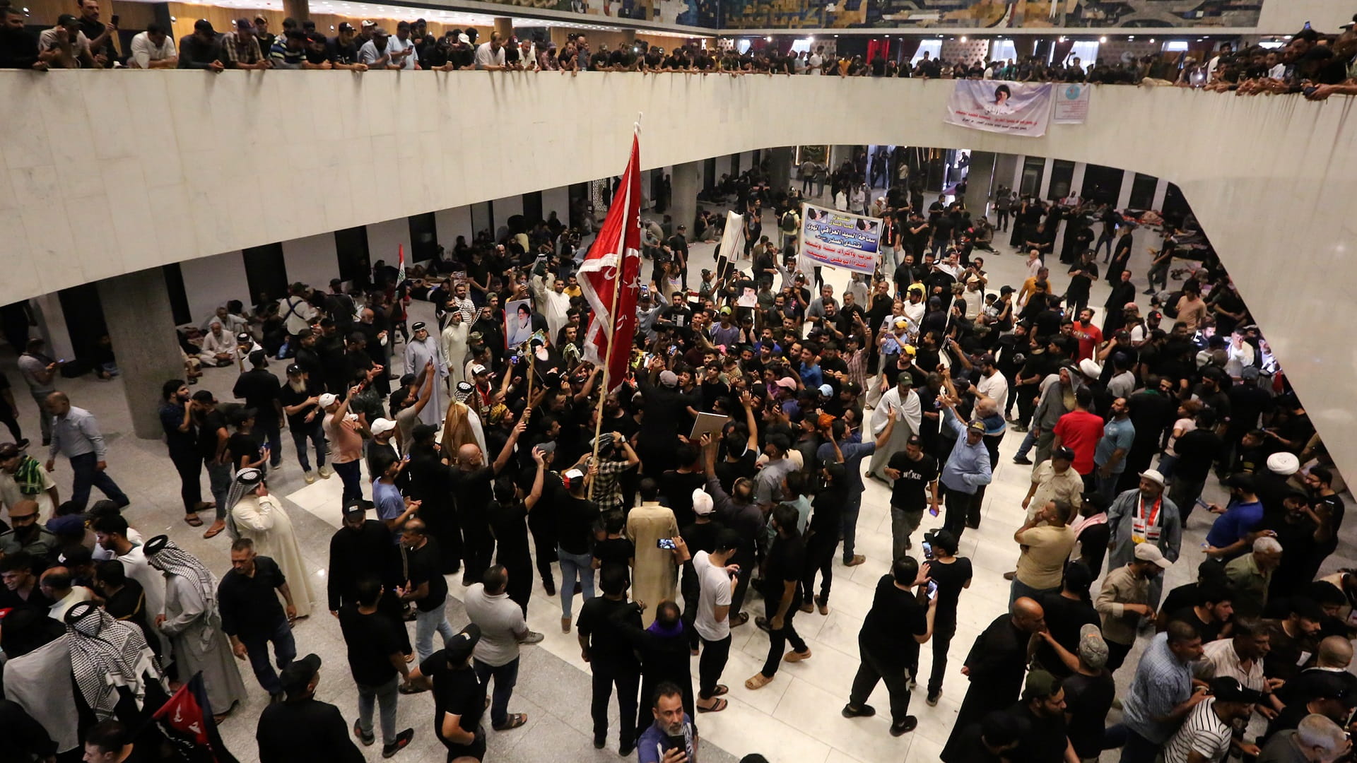 Image for the title: Hundreds camp at Iraqi parliament for second day 