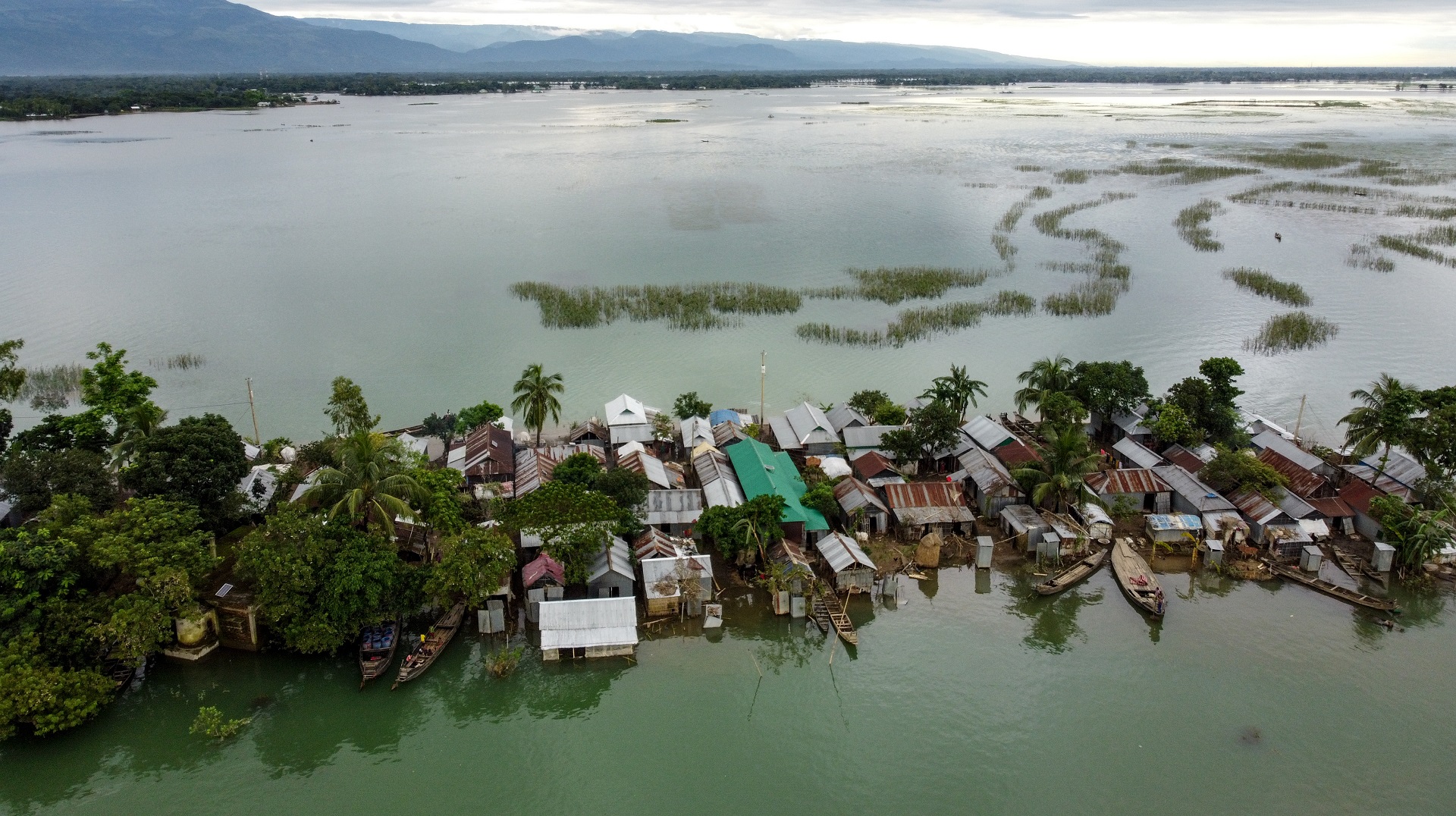 Image for the title: Bangladesh monsoon floods claim 25 lives, strand four million 