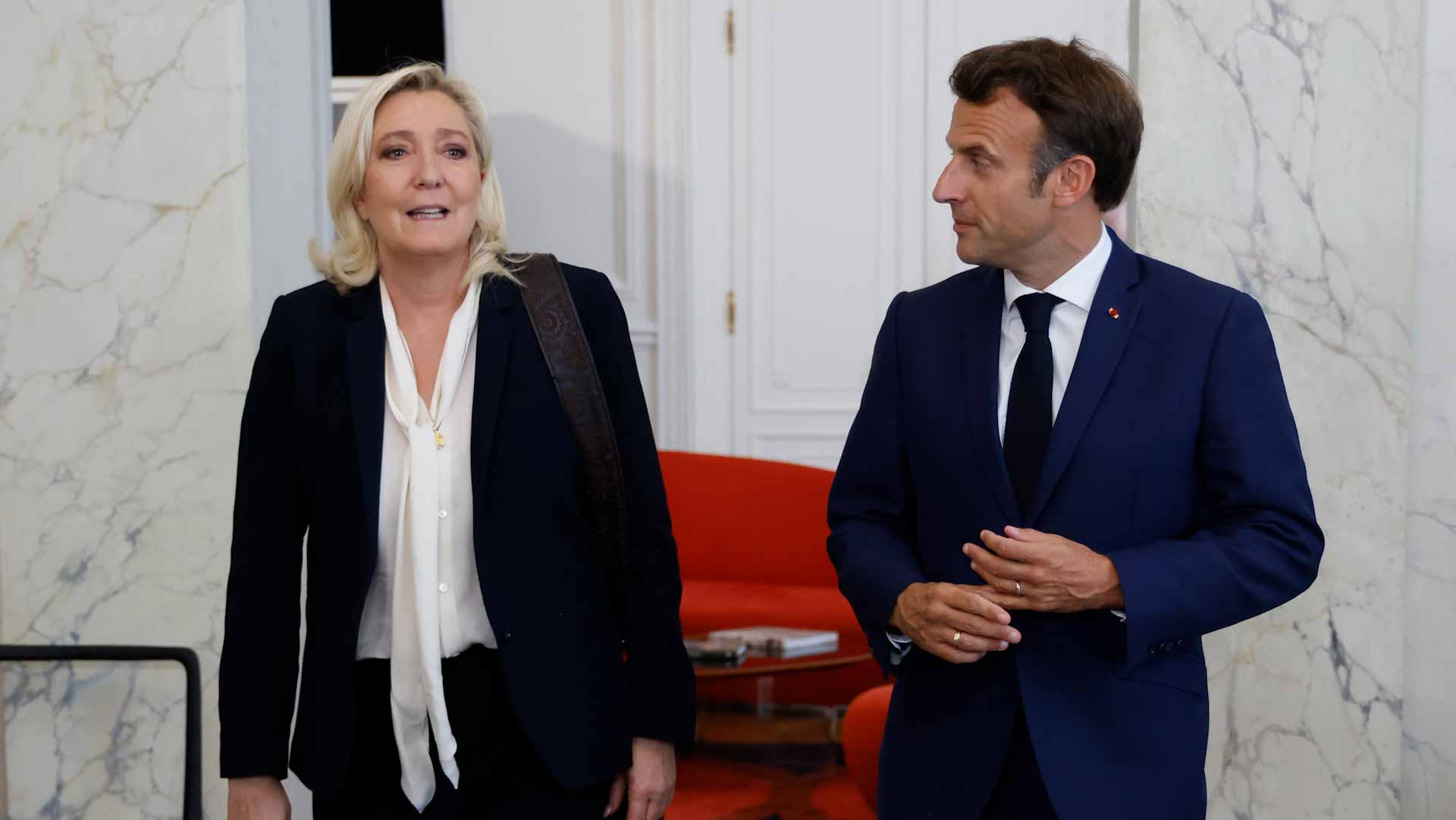 Image for the title: Macron meets France opposition, retains PM after poll blow 