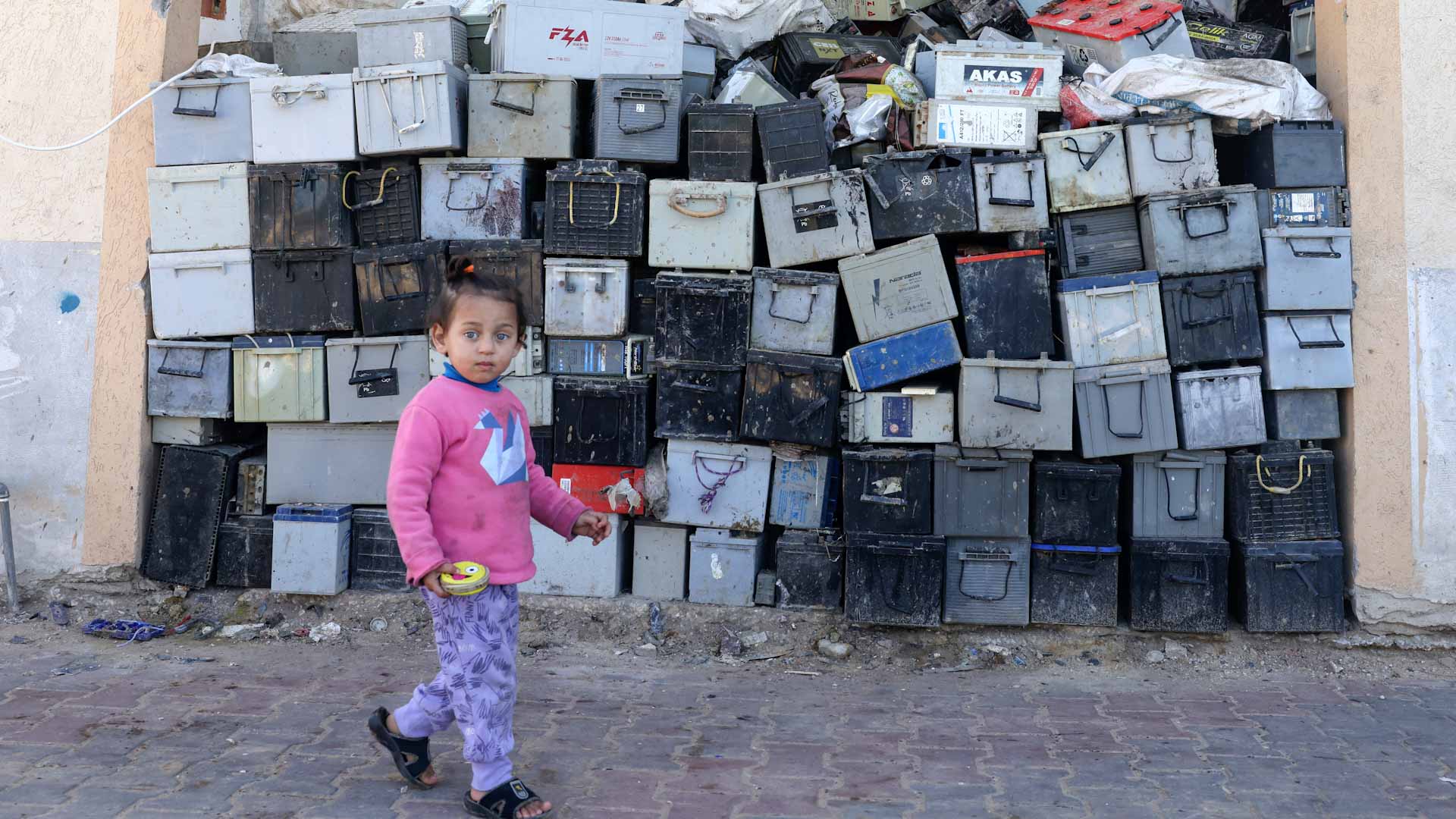 Image for the title: Mounds of old batteries threaten Gaza health 