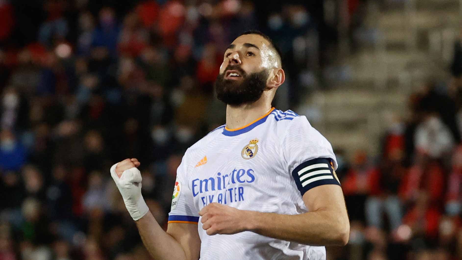 Image for the title: Benzema scores twice but hurts ankle as Real extend LaLiga lead 