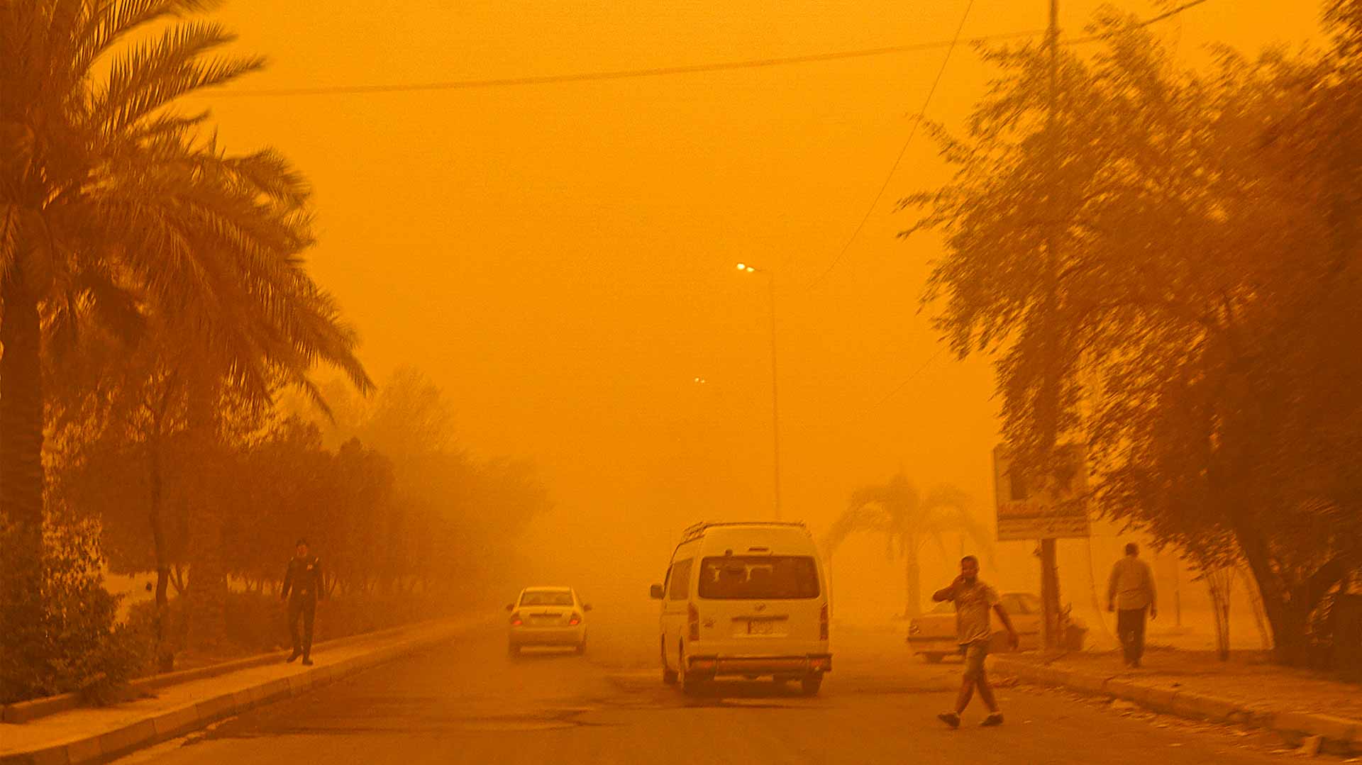 Image for the title: Sky turns orange as sandstorm hit Iraqi capital Baghdad 