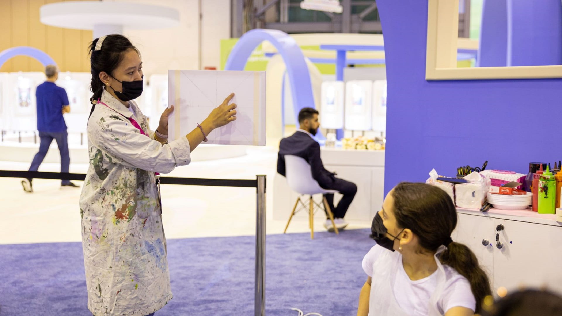 Image for the title: Children try their hand at Islamic tile painting at SCRF 2022 