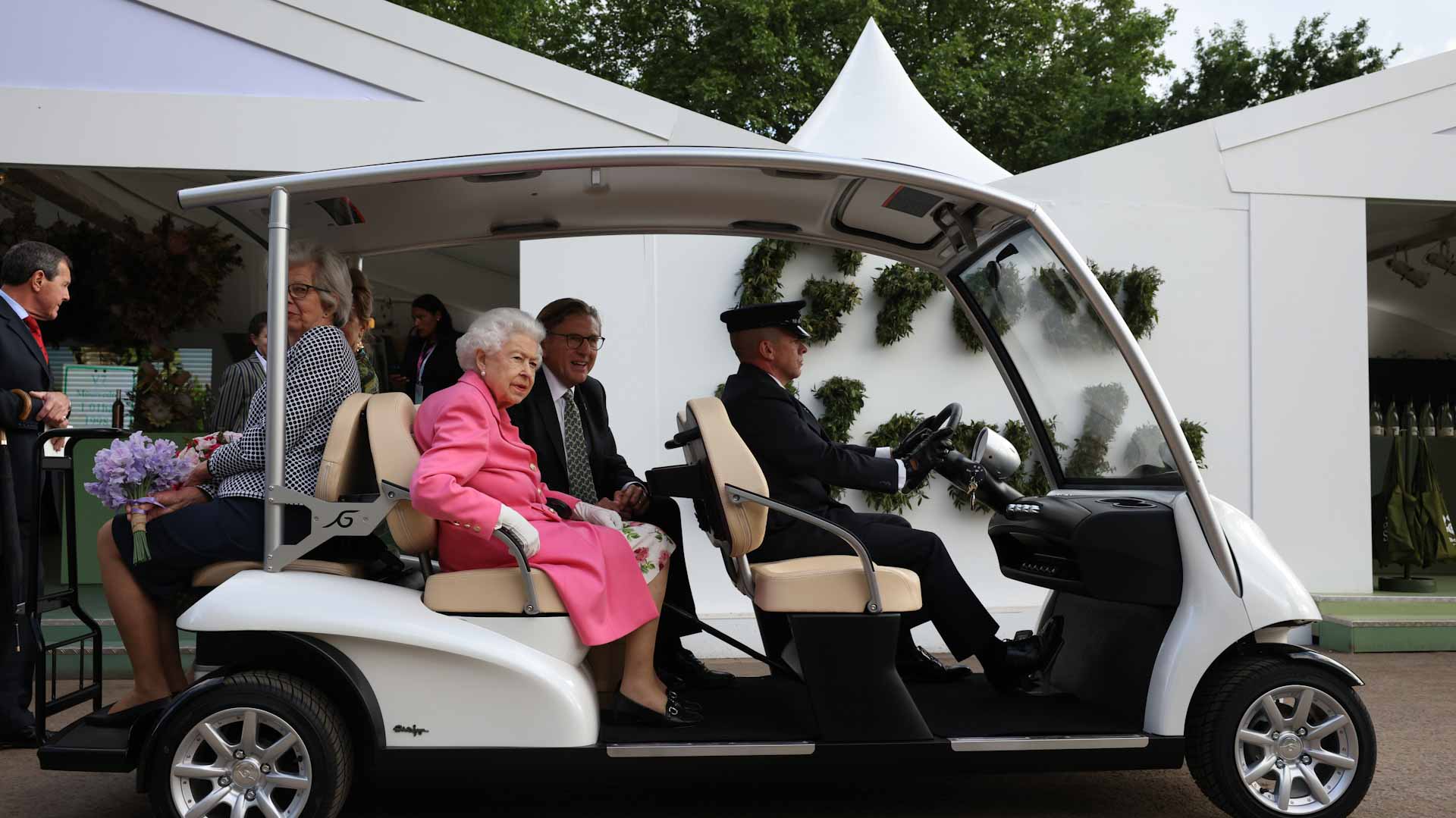 Image for the title: Chelsea Flower Show: unexpected gardeners and queen in a buggy 