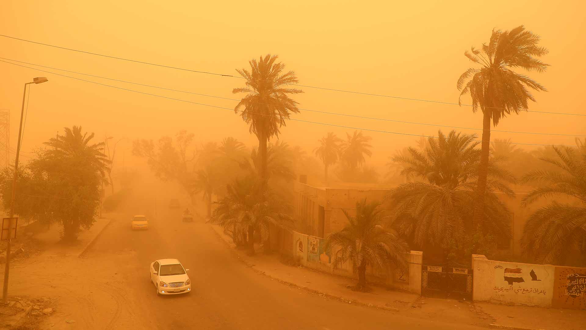 Image for the title: Iraq sandstorm grounds flights, sends 1,000 to hospitals 