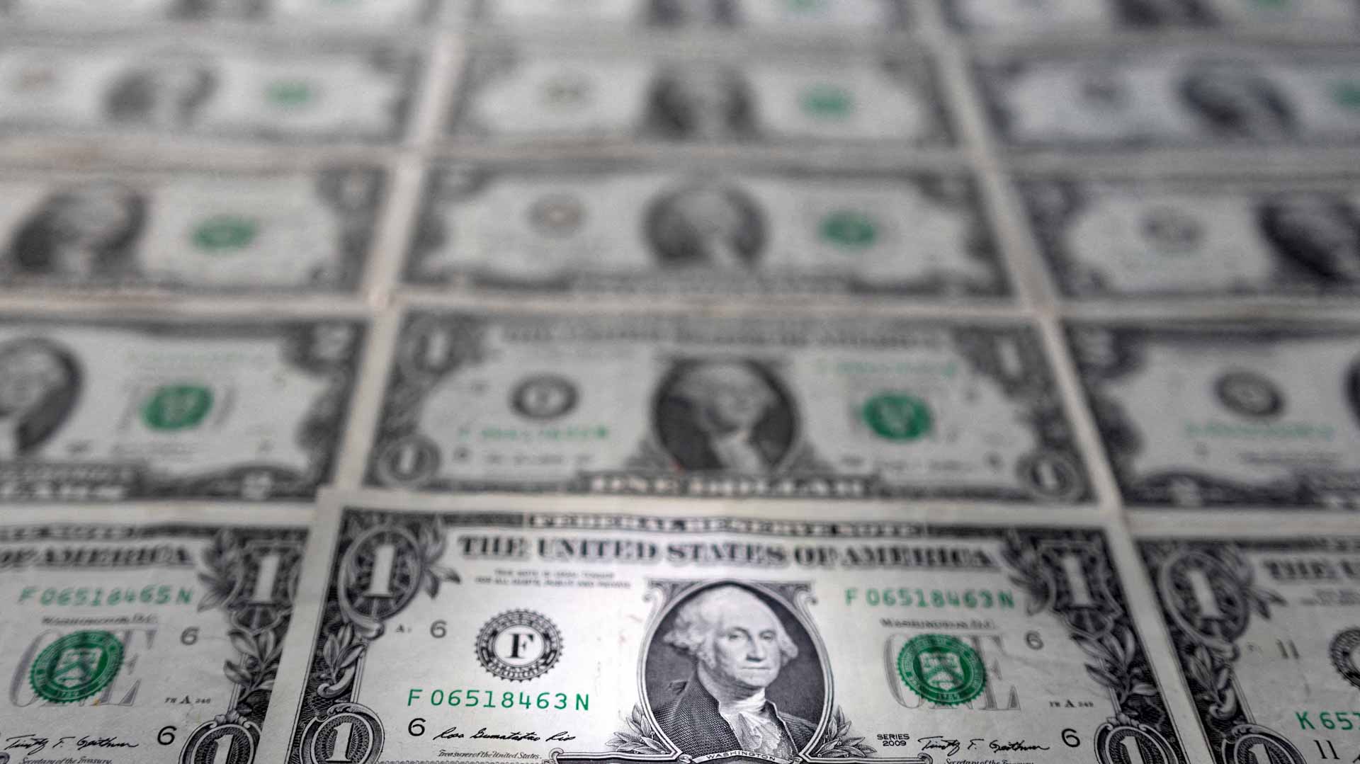 Image for the title: Dollar drifts toward monthly loss as Fed bets ease 