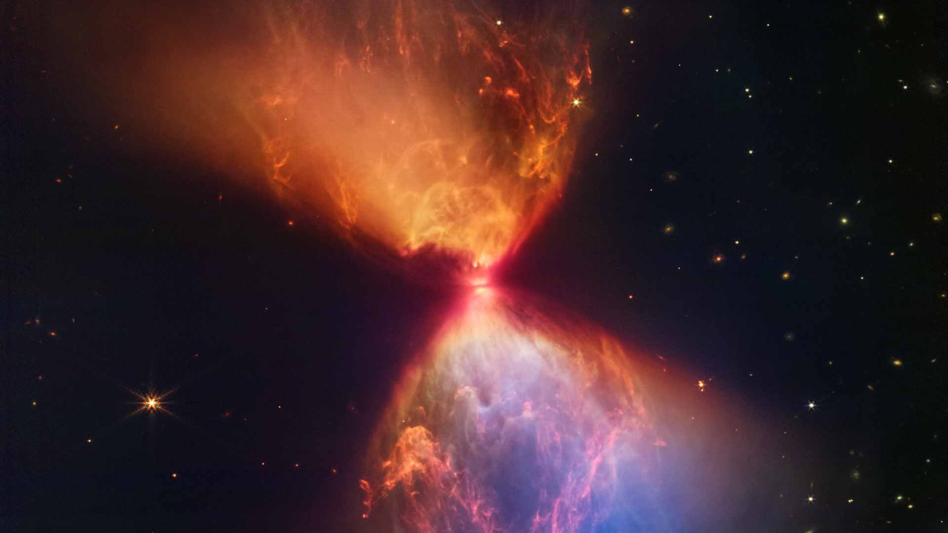 Image for the title: Webb telescope reveals blazing hourglass around forming star 