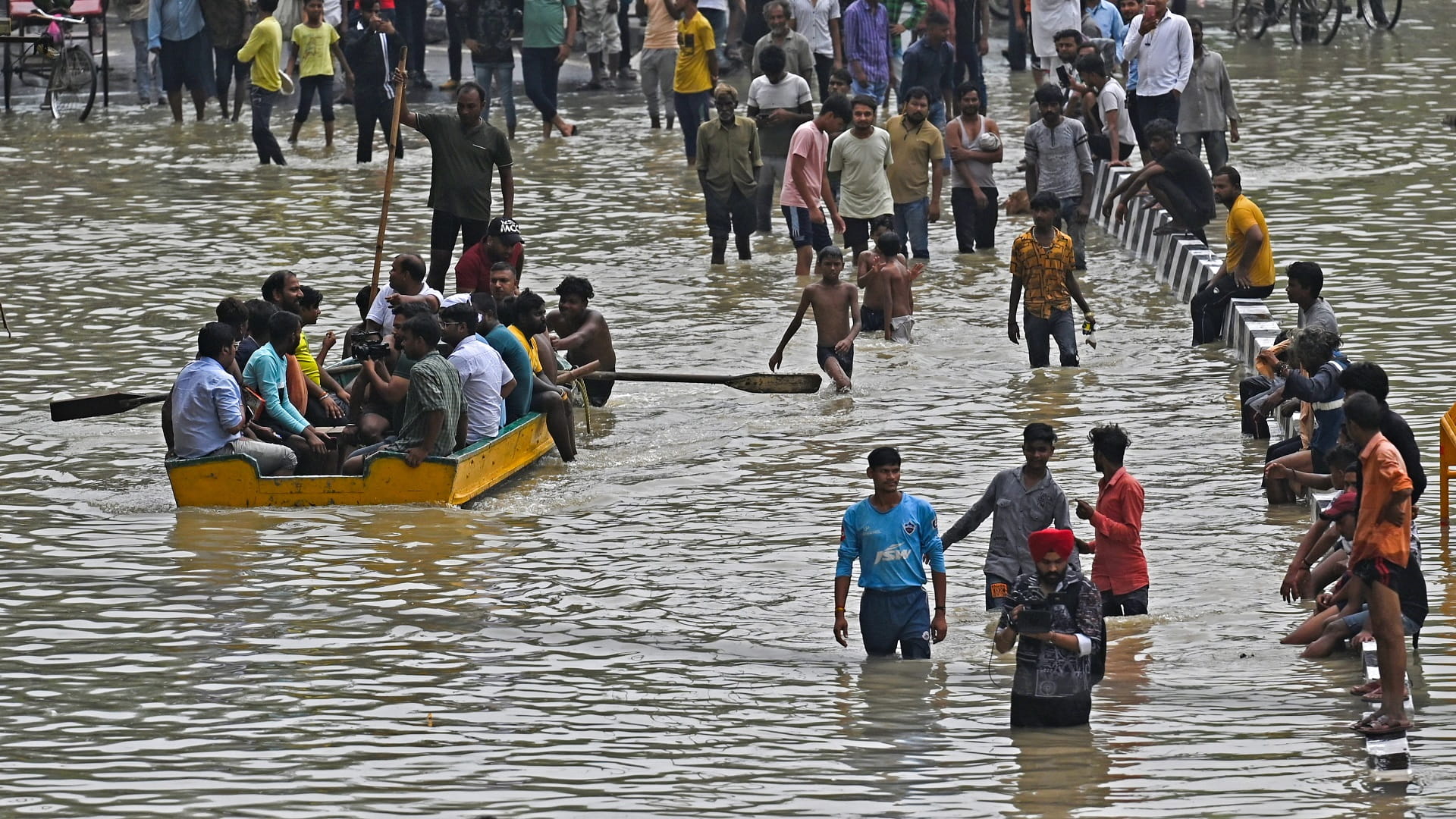 Image for the title: New Delhi floods leave life out of gear, hit the poor hardest 