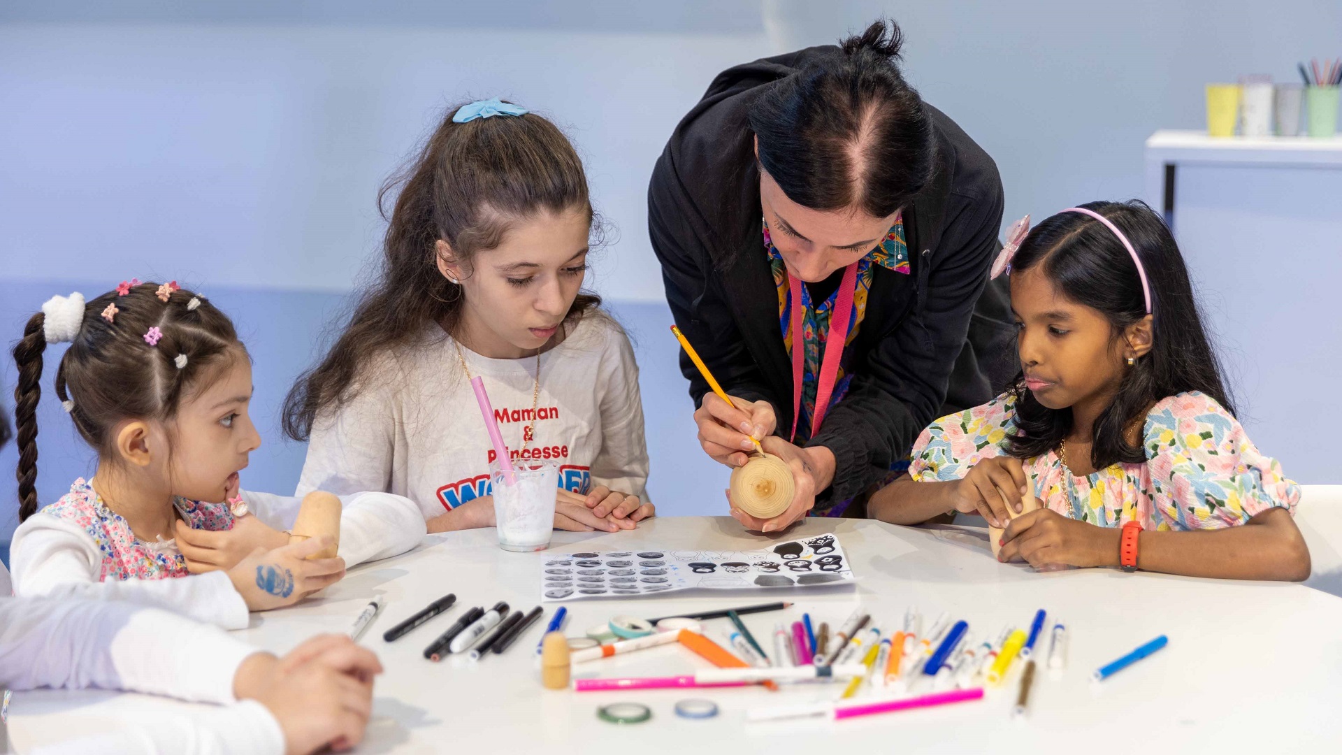 Image for the title: Children learn about nesting dolls at SCRF 2024 