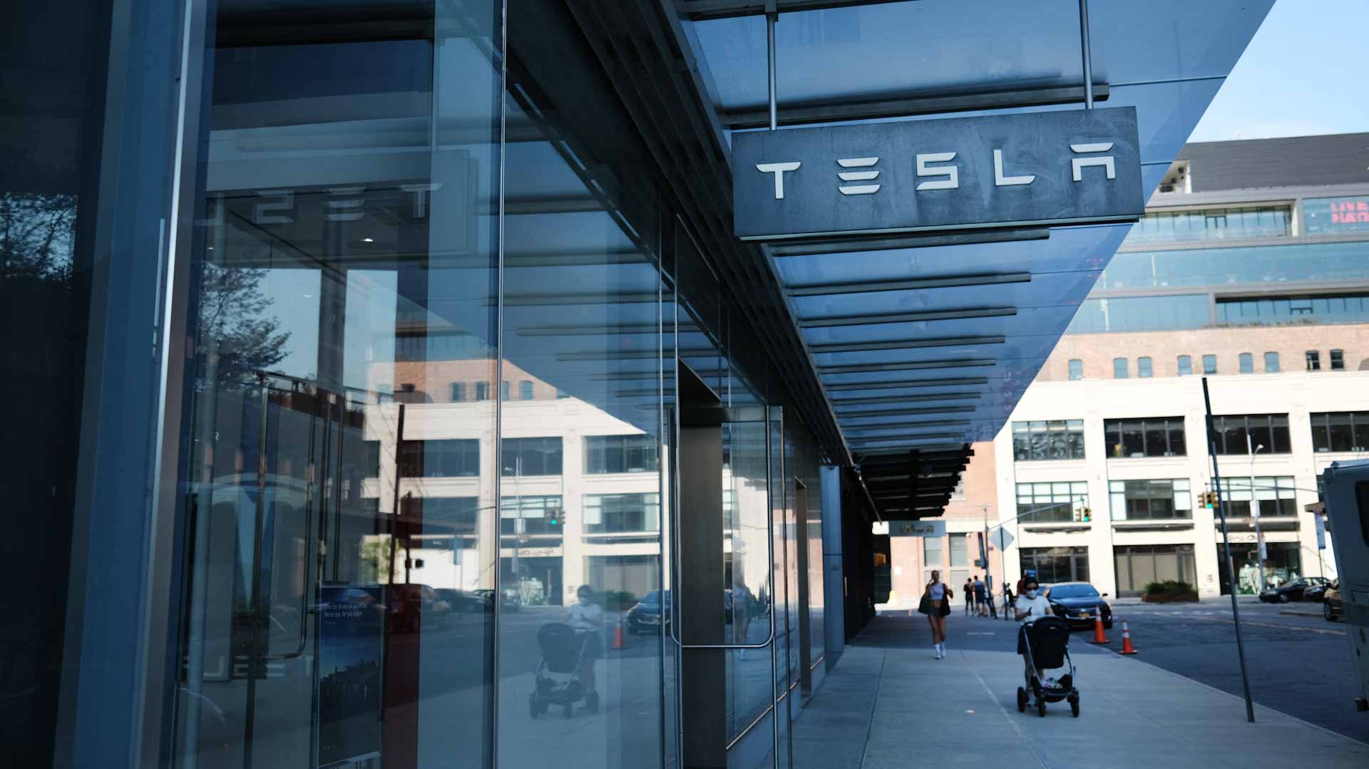 Image for the title: Tesla helps drive stocks mostly higher 