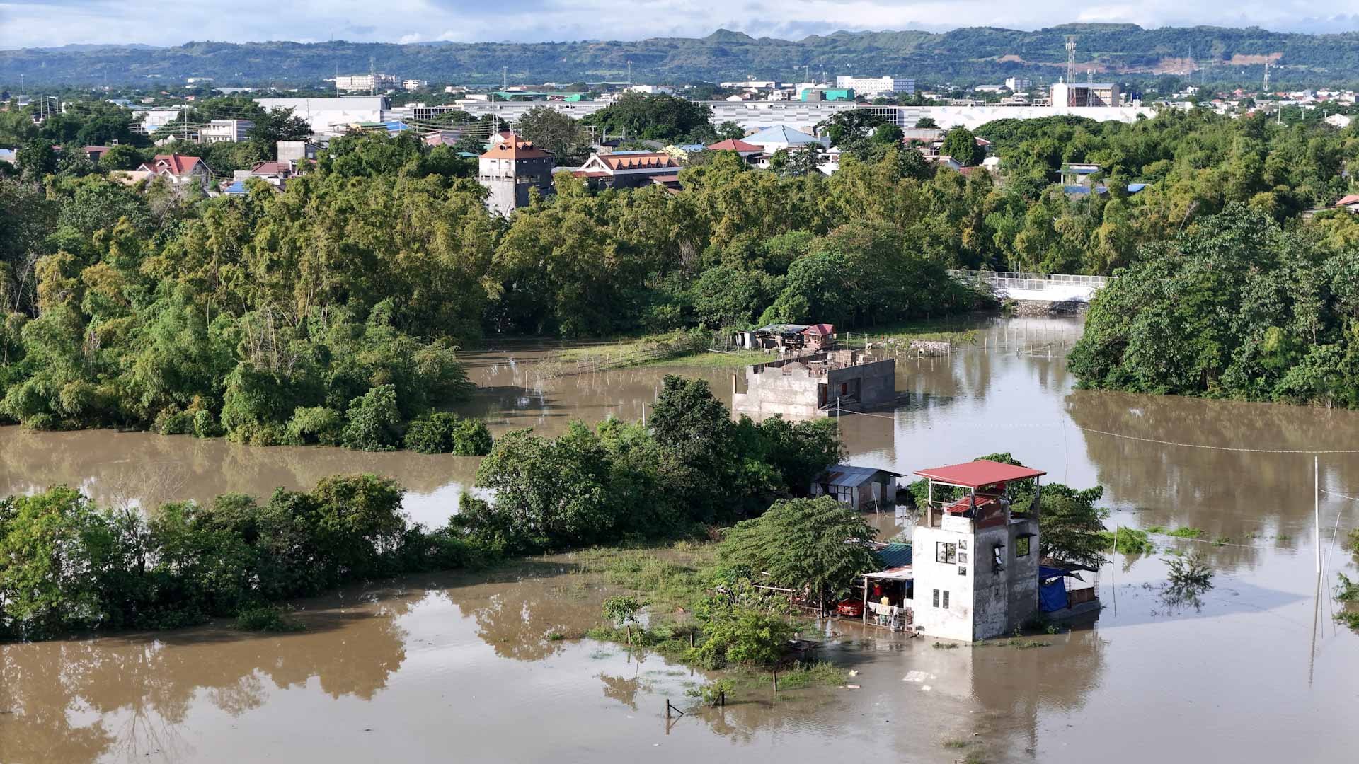 Image for the title: Philippine rescuers battle floodwaters to reach stranded 