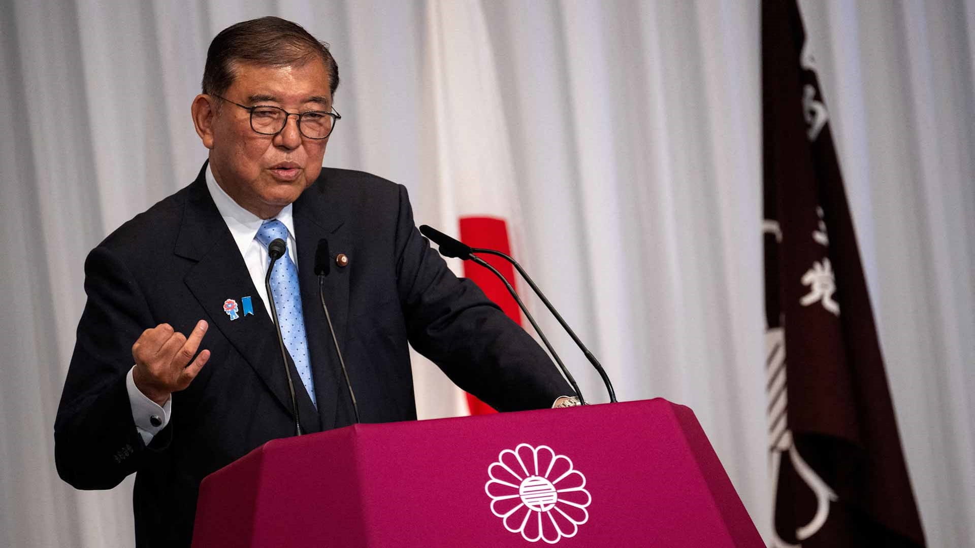 Japan PM vows to stay on after bruising election defeat