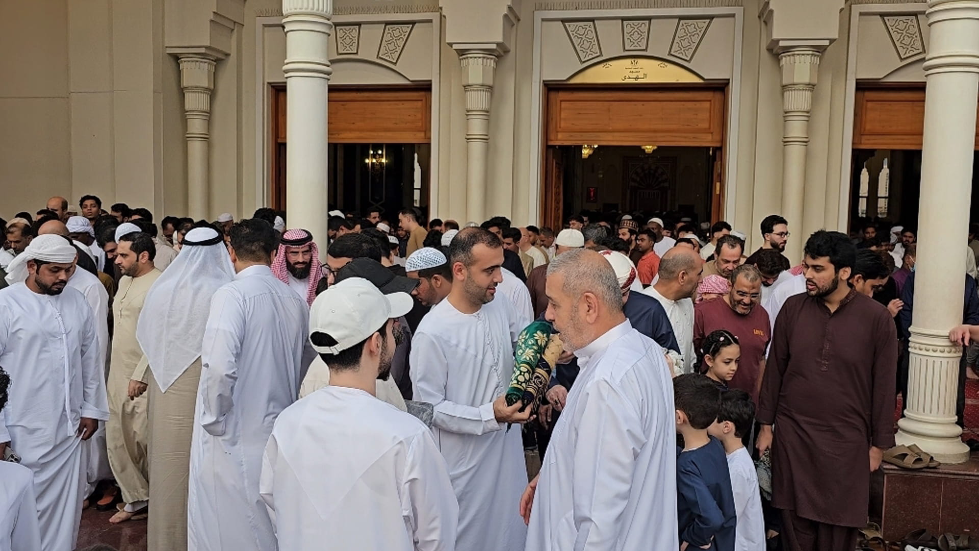 Image for the title: Worshippers exchange Eid al-Fitr greetings 