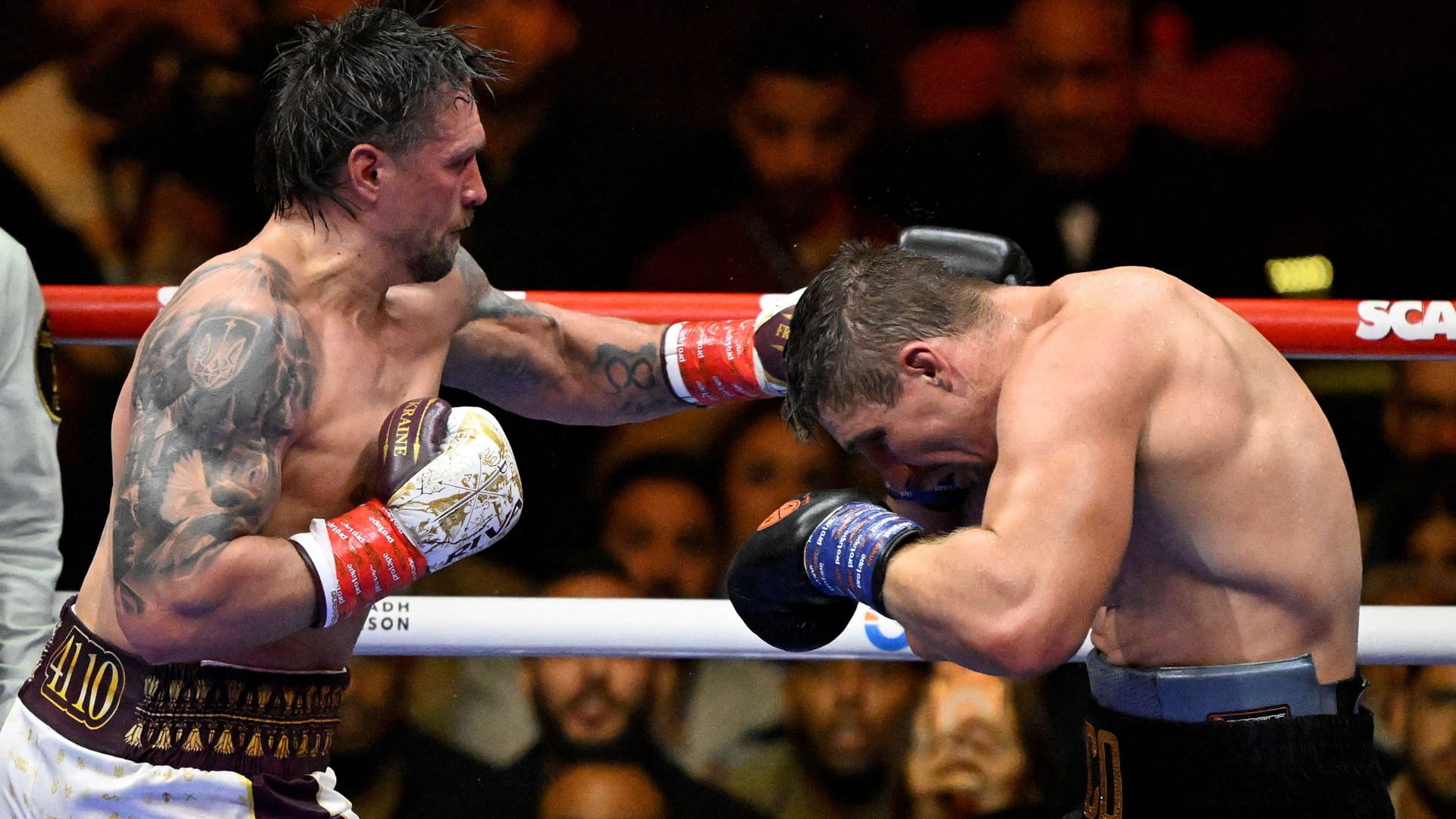 Image for the title: Usyk rocked before stopping Verhoeven to retain heavyweight belts 